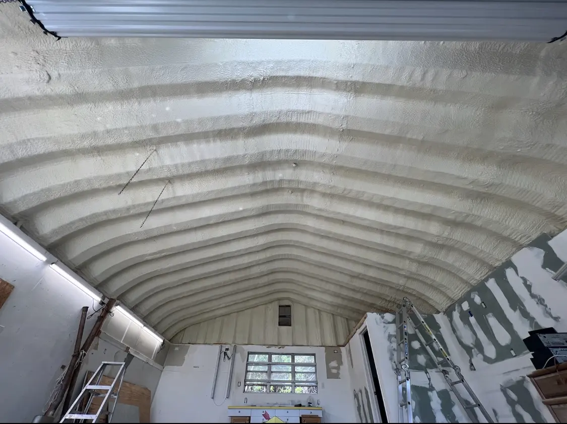 Spray polyurethane foam applied to the underside of a metal roof deck in Mission